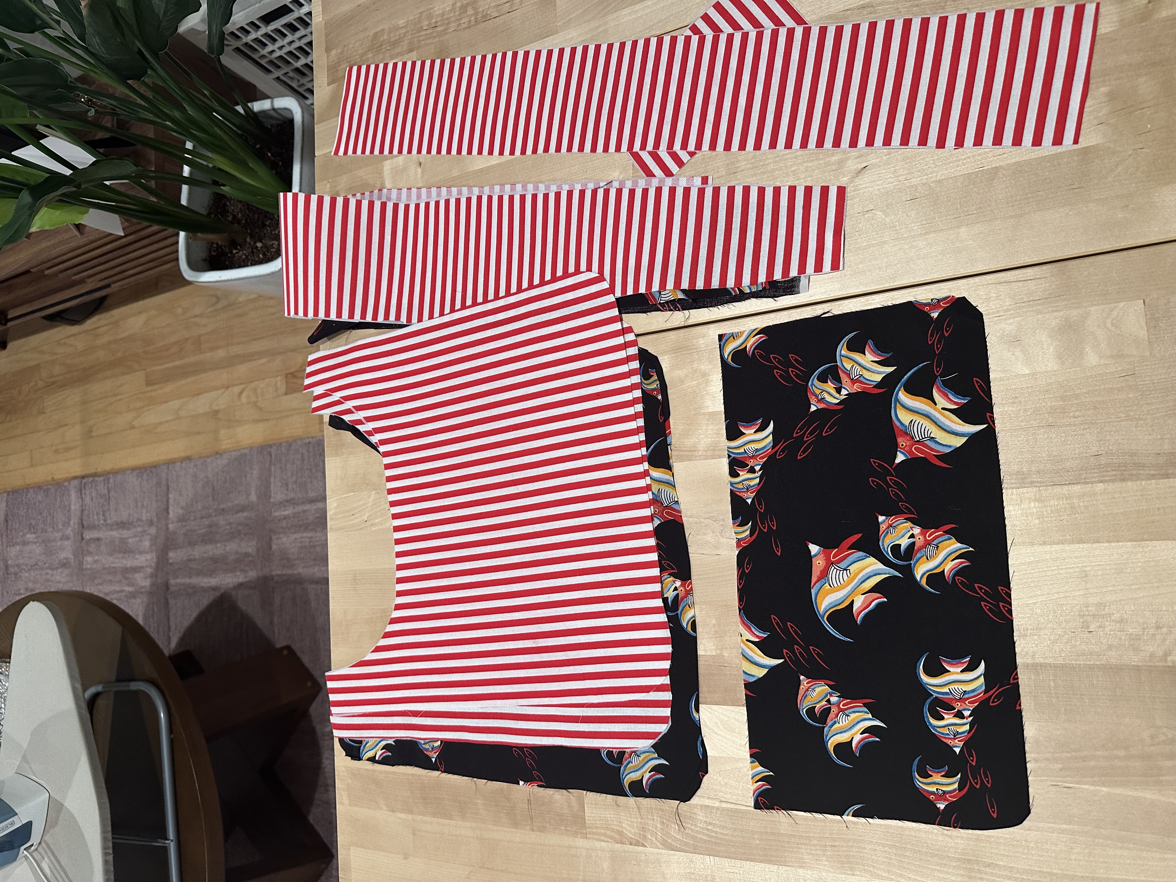 Cut pieces of the red and white striped outer fabric and the fish print lining fabric for the Billy Bag